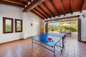 a ping pong table in the middle of a room at Villa Manresa in Alcudia by JS Villas in Alcudia