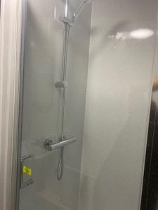 a shower with a glass door in a bathroom at 2 Bedroom Flat room 13 in Stockton-on-Tees