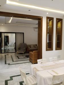 a living room with two beds and a couch at Villa Dar Nejib - Duplex de luxe 2S+4 à cité El Wafa in Nabeul