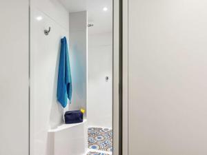 a room with a closet with a blue umbrella at hotelF1 Le Mans Nord in Saint-Saturnin