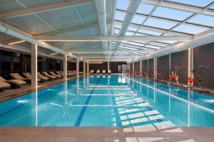 a large swimming pool in a building at Ramada Plaza by Wyndham Batumi & Casino in Batumi