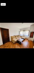 sala de estar con sofá y mesa de centro en V.V. familiar en Arinaga