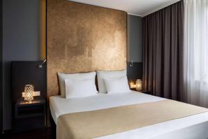 Łóżko lub łóżka w pokoju w obiekcie Amedia Luxury Suites Graz, Trademark Collection by Wyndham