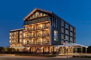 a tall black building with lights on at Hilton Garden Inn Busselton in Busselton