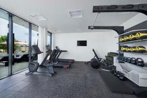 a gym with treadmills and tread machines in a room at Hilton Garden Inn Busselton in Busselton