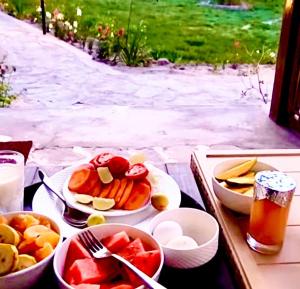 a table with plates of food and bowls of fruit at Royal Soma Resort in Stak