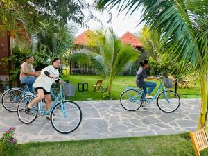 a group of people riding bikes on a path at Bum King Resort Hồ Tràm in Xuyên Mộc