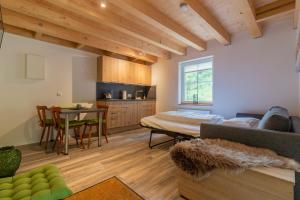 a living room with a bed and a table at Rursee Schilsbachtal - Naturnahe Auszeit am Rursee - Eifel-Ferienwohnungen der besonderen Art in Simmerath