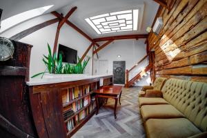 a living room with a couch and a tv and books at Tóni Villa in Budapest