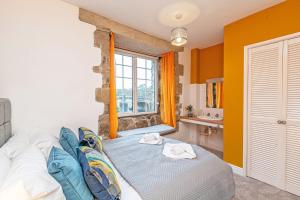 Ένα ή περισσότερα κρεβάτια σε δωμάτιο στο Bridge End Mill Holiday Apartments