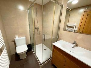 a bathroom with a shower and a toilet and a sink at Apartamentos Jaca Ciudadela 3000 in Jaca