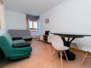a living room with a table and chairs and a couch at Apartamentos Jaca Ciudadela 3000 in Jaca