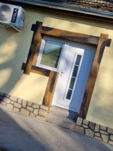 a door with a cross on the side of a house at Apartman Sparta in Sombor