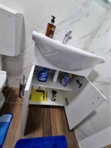 a bathroom with a sink and toothpaste at Apartman Sparta in Sombor