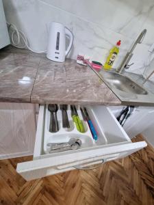 a drawer in a kitchen counter with a sink at Apartman Sparta in Sombor