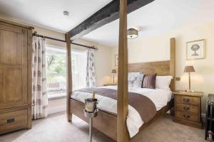 a bedroom with a canopy bed and a window at Timble Inn in Timble