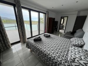 a bedroom with a bed and a view of a balcony at Villa Claudie in Les tres Cales +10 photos