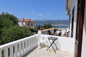a white balcony with a table and chairs on it at Holiday home in Silo/Insel Krk 26681 in Šilo