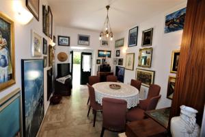 a dining room with a table and a bunch of pictures at Holiday home in Silo/Insel Krk 26681 in Šilo