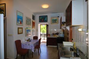a kitchen with a sink and a table with chairs at Holiday home in Silo/Insel Krk 26681 in Šilo