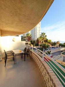 a balcony with a table and chairs on a building at Olivar Beach by Agencia Poniente in Benidorm