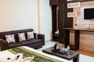 a hotel room with a bed and a couch at Hotel Pushkar Legacy in Pushkar