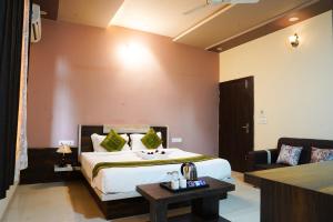 a hotel room with a bed and a couch at Hotel Pushkar Legacy in Pushkar