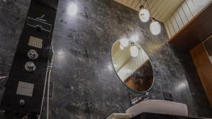 a bathroom with a mirror and a sink at Hotel Pushkar Legacy in Pushkar
