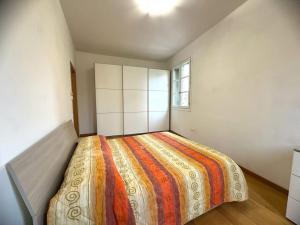 a bedroom with a large bed in a room at Appartamento Corte Salvemini in Bologna
