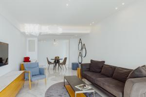a living room with a couch and a table at Golden Bay Beach Hotel in Larnaca