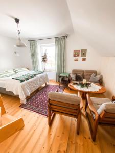 a bedroom with a bed and a living room at Istebna 401 MURY in Istebna +121 photos