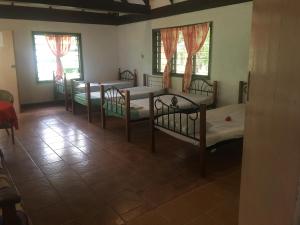 a group of four bunk beds in a room at Yasawa Long Beach Hideout Resort in Vuake