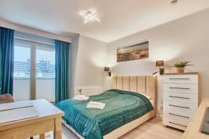 Säng eller sängar i ett rum på Pegaz Apartments by Baltic Home