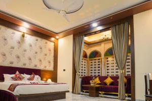 a hotel room with a bed and a couch at Hotel Pushkar Legacy in Pushkar