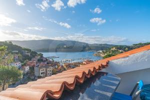 a view of a river and a city from a balcony at Il Porto 25 Mansarda sul Mare - Goelba in Porto Azzurro