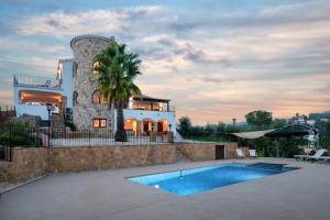 a house with a swimming pool in front of it at Villa Los Primos in Calonge