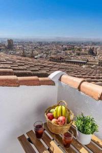 a basket of fruit on a table on a balcony at Hi Granada Suite A in Granada