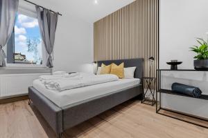 Säng eller sängar i ett rum på Frisch renovierte Wohnung - Zentral/Ruhig/Modern