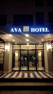 a hotel with a blue sign on the front of it at เอวา โฮเทล อุดรธานี (AVA Hotel Udonthani) in Ban Chang