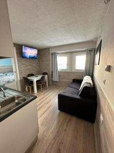 a living room with a couch and a table at BELLAVISTA APARTMENT in Passo del Tonale