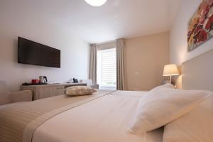 Postel nebo postele na pokoji v ubytování Hotel Magdalena