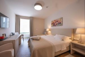 Postel nebo postele na pokoji v ubytování Hotel Magdalena