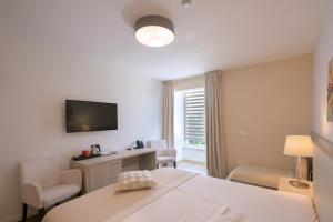 Postel nebo postele na pokoji v ubytování Hotel Magdalena