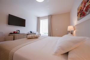 Postel nebo postele na pokoji v ubytování Hotel Magdalena