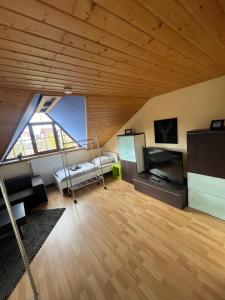 a room with a loft with a bed and a refrigerator at Ferien/Monteur Wohnung Gapp in Bad Waldsee