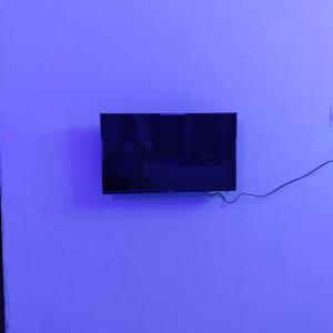 a flat screen tv hanging on a wall at Maya home stay in Kolkata