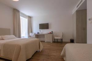 Postel nebo postele na pokoji v ubytování Hotel Magdalena