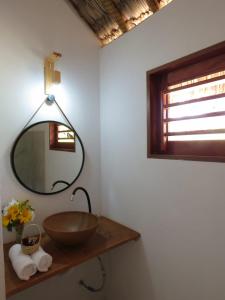 a bathroom with a bowl sink and a mirror at Pitico Chalé - Icaraí Kite Village in Icaraí