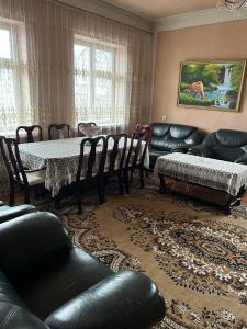 a living room with a table and leather furniture at Apartment in Tsaghkadzor