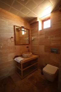 a bathroom with a sink and a toilet and a mirror at Hotel İzi Cappadocia in Urgup